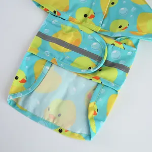 Detailed view of waterproof pet dog raincoat with cute duck print and safety reflective strip.