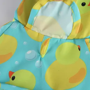Close-up detail of cute duck pattern pet dog raincoat hooded waterproof fabric design.