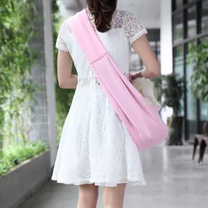 Breathable pink pet sling bag, comfortable cross-body carrier for small dogs and cats outdoors.