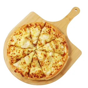 Natural bamboo pizza peel with freshly baked sliced pizza on white background for detail view.