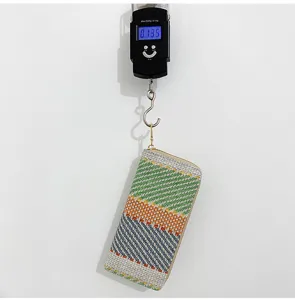 Detail view showing the 135g weight of this multi-colored woven linen clutch bag