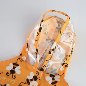 Close up pet raincoat hood detail, cute yellow bee print, waterproof clear brim design.