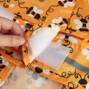 Cute bumblebee print dog raincoat with secure velcro closure and reflective safety strip.