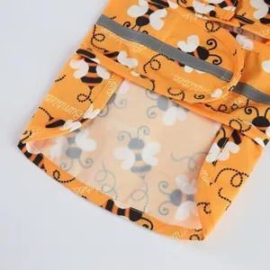 Cute bee pattern pet dog raincoat detail shot with reflective strips, waterproof and breathable.