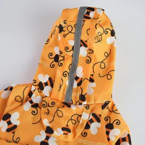 Cute yellow dog raincoat hood detail with reflective strip and waterproof bee pattern fabric.