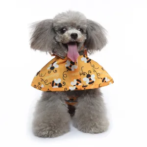 Cute grey poodle wearing a yellow bee print pet raincoat with hood for rainy days.