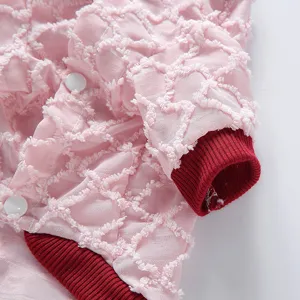 Dettaglio macro della maglia rosa per animali con tessuto traspirante e polsini rossi