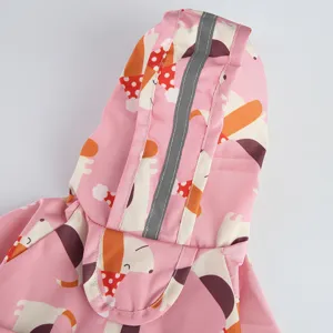 Pink cute dog raincoat detail with reflective stripe, waterproof pet apparel for rainy days.