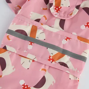 Pink pet raincoat detail featuring waterproof fabric, cute cartoon print, and safe reflective strip.