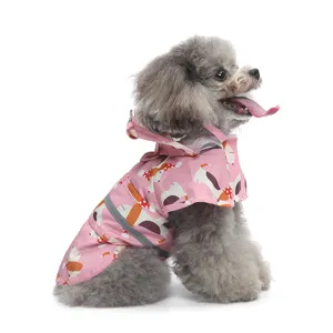 Close-up detail of the cute pink pet dog raincoat with hood, cartoon print and reflective strip.
