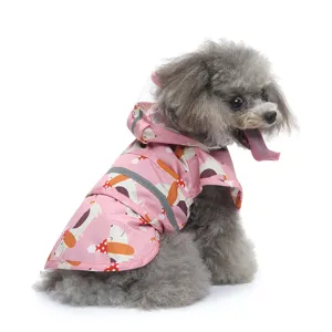 Detailed view of the pink pet raincoat featuring a cute animal print and reflective safety strip.