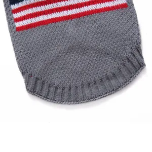 Close-up detail view of gray pet dog sweater featuring red white and blue knit striped hem.