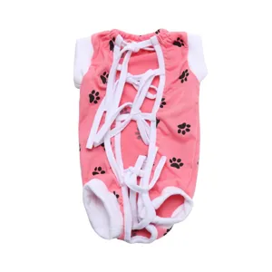 Detailed view of the pink pet surgical recovery suit with cute black paw print patterns and ties.