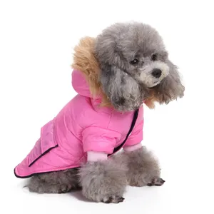 Detail view of a pink hooded dog winter jacket with luxury faux-fur trim for warmth