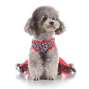 Pet dog dress detail showing black and white pattern with red trim and lace edge.