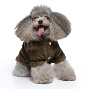 Detailed view of the brown plush pet bathrobe with button design on a small grey poodle
