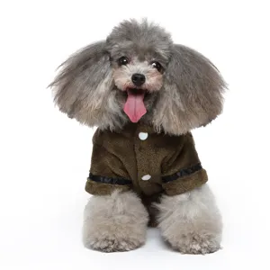 Detailed view of the soft brown plush pet bathrobe with white buttons on a grey dog