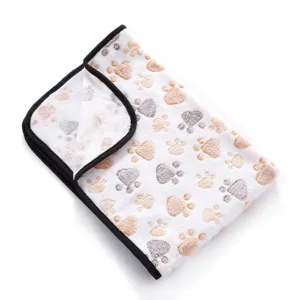 Soft double-sided fleece pet blanket with cute paw print pattern and neat black bound edges.