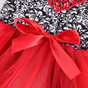 Pet dog summer dress detail close up, featuring cute red satin bow and mesh skirt fabric.