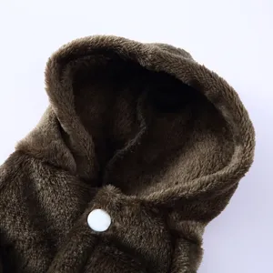 Macro detail of soft brown plush pet bathrobe fabric featuring a sturdy white snap button
