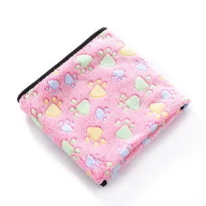 Soft pink fleece pet blanket detail, colorful paw prints, cozy cat and dog sleeping mat.