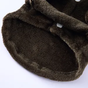 Close-up of soft brown plush fabric and white snap buttons of a cozy pet bathrobe for dogs.