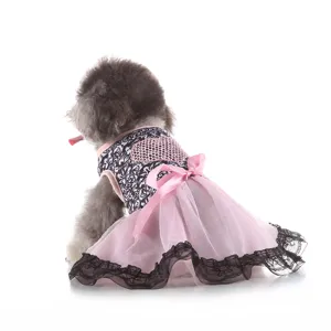 Detailed view of cute pet dog dress with black white print and pink mesh skirt bow.