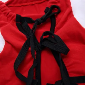 Pet surgical suit detail close-up, breathable red fabric with secure black tie straps.