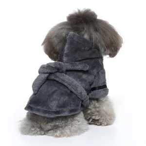 Detail view of a soft charcoal gray plush dog bathrobe with hood and belt on a poodle dog