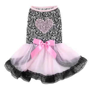 Detailed shot of a stylish black and white pet dress with pink heart and bowknot.