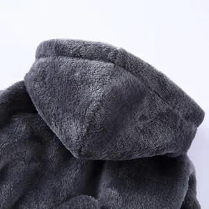 Detailed macro shot of grey plush fabric on a hooded pet bathrobe pajamas