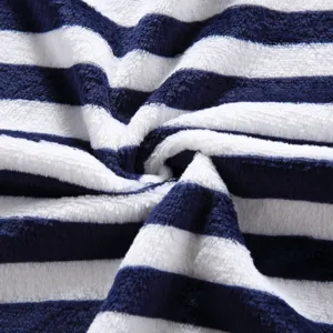 Blue and white striped soft fleece blanket detail showing plush texture and cozy fabric.