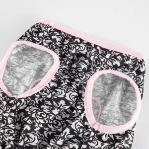 Close-up detail of pet summer clothes with black and white damask pattern and pink trim.