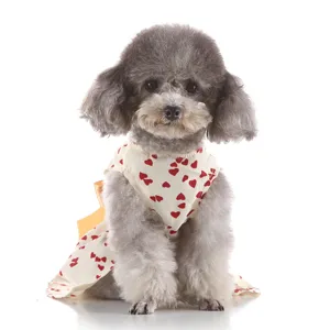 Closeup detail of cute puppy summer dress featuring sweet red heart prints and bow accessory.
