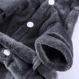 Macro detail of dark gray plush pet bathrobe with soft fleece texture and white buttons