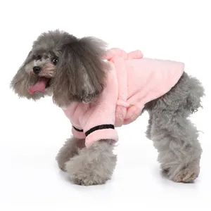 Side view of a small grey dog wearing a cozy soft pink plush hotel style pet bathrobe
