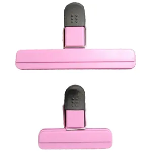 Detailed macro view of pink plastic food sealing clips in long and short sizes for kitchen use