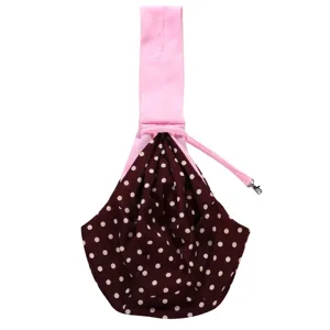 Detail view of breathable pet sling bag, pink strap with brown polka dots pouch for dog.