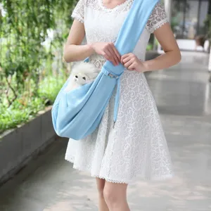 Detail shot of light blue pet sling bag with adjustable strap for outdoor travel.