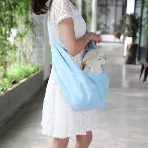 Light blue pet sling bag breathable crossbody puppy carrier for small dogs outdoor travel.