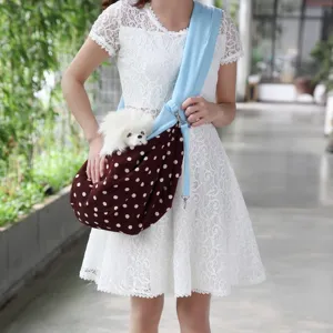 Comfortable breathable pet sling bag with polka dot design for small dogs and cats outdoor use.