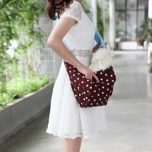 Breathable pet carrier sling bag for dogs and cats, comfortable cross-body outdoor pouch.