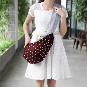 Detailed view of the pet sling bag featuring breathable fabric and cute polka dot design.