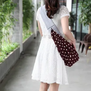 Breathable pet sling bag, polka dot crossbody carrier for small dogs and cats outdoors.