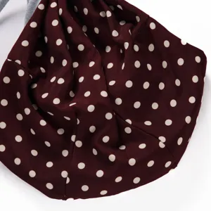 Burgundy polka dot pet carrier fabric detail, soft breathable material close-up view.