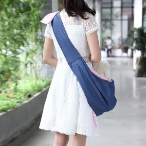 Breathable denim pet sling carrier bag, comfortable crossbody puppy dog backpack for travel.