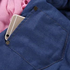 Pocket detail of breathable blue denim pet bag with metal rivets showing outdoor convenience.