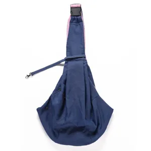 Detailed view of the blue denim pet sling showing secure safety buckle and soft lining.