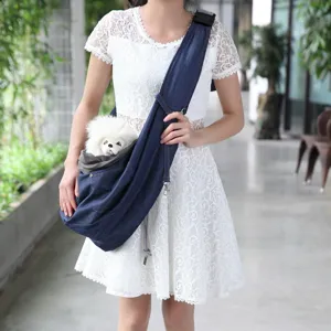 Close-up detail of the breathable denim pet sling bag worn by model, showcasing adjustable strap.