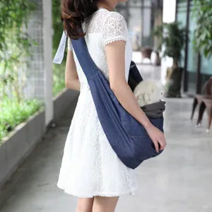 Breathable denim pet sling carrier for small dogs, portable outdoor cross-body pet bag.